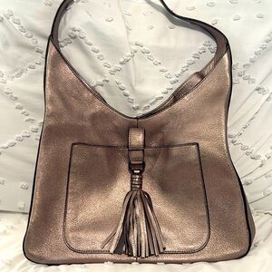 Vince Camuto gold metallic bag with tassel.
